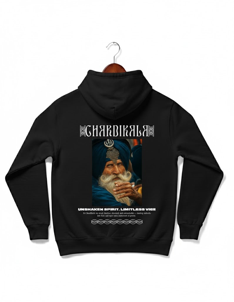 Chardikala Hoodie by Pardesi Drip — premium black hoodie showcasing a Nihang Sikh elder symbolizing unshaken spirit, positivity, and eternal optimism. Detailed Khanda emblem and typography celebrate Punjabi resilience and cultural pride.