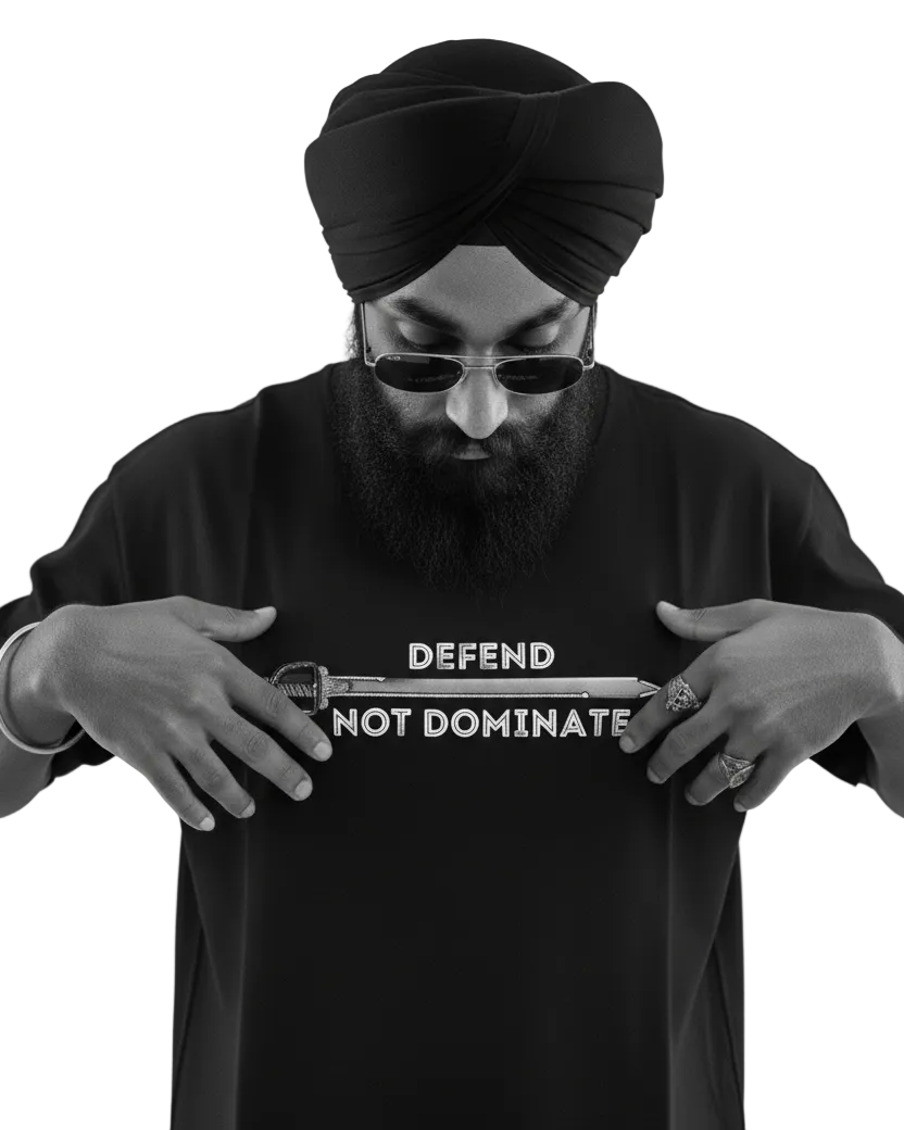 Person wearing a black t-shirt with 'DEFEND NOT DOMINATE' text, holding a gun prop.