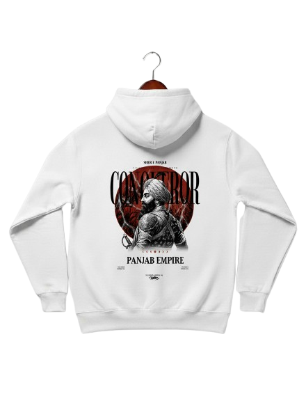 A white hoodie is displayed on a wooden hanger, facing away from the viewer. The back of the hoodie features a detailed graphic with the word "CONQUEROR" prominently displayed in a red font, partially obscuring an illustration of a historical figure with a turban and beard, holding a weapon. Below this, the text "PANJAB EMPIRE" is visible. The design also incorporates subtle red and black elements, suggesting an intense or powerful theme. The background is plain white.