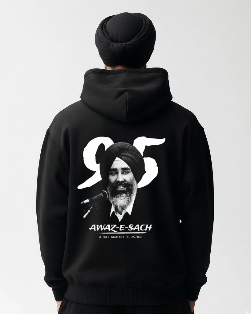 Person wearing a black hoodie with a graphic and text on the back, on a plain background