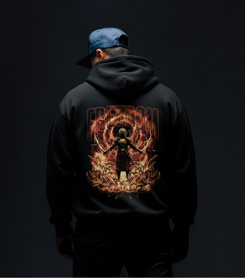 Person wearing a black hoodie with a fiery graphic design on the back against a dark background