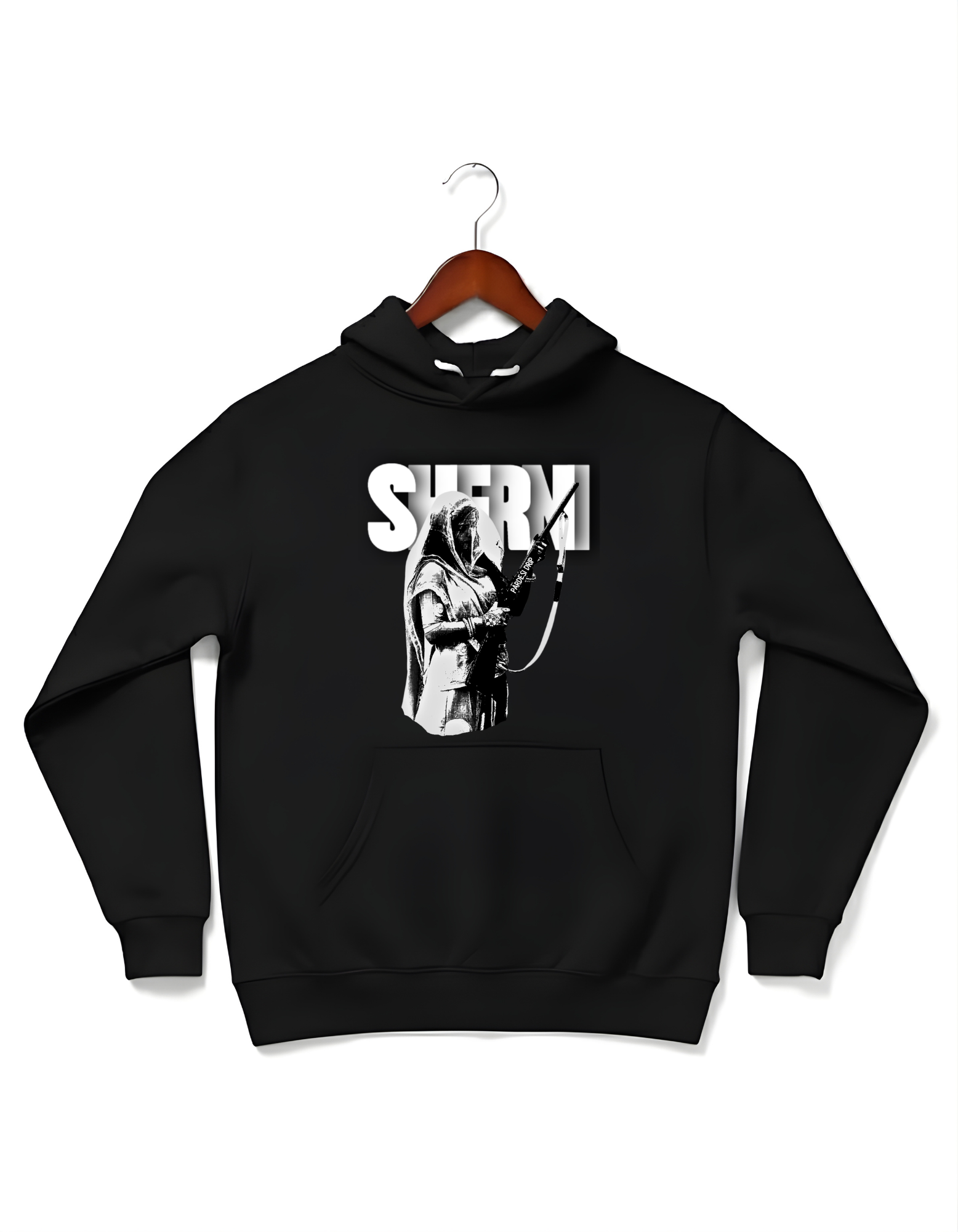 Black oversized Cotton Fleece hoodie and high-top sneakers. The hoodie features a large, bold graphic of a historical figure, Maharani Jindan Kaur, with the word "SHERNI" in large white block typography in the background. The design is loud, graphic, and culturally inspired.